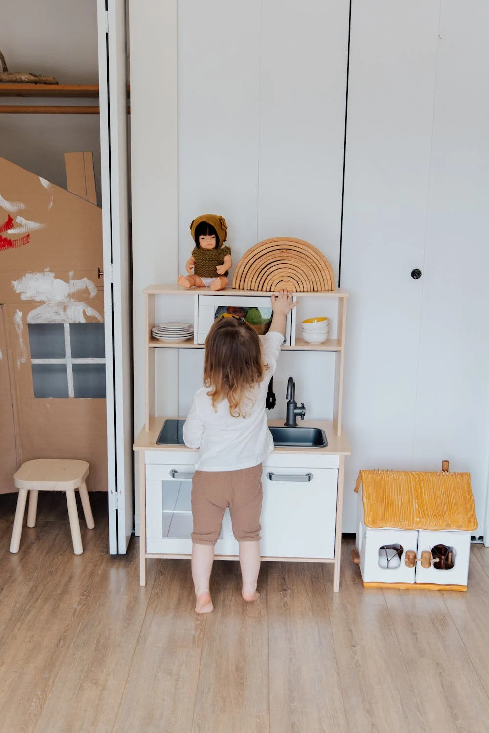 child trying to grab something from top shelf