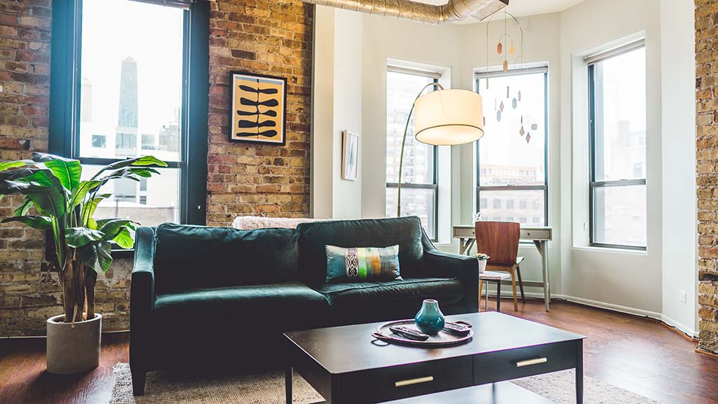 flat with couch and exposed brick